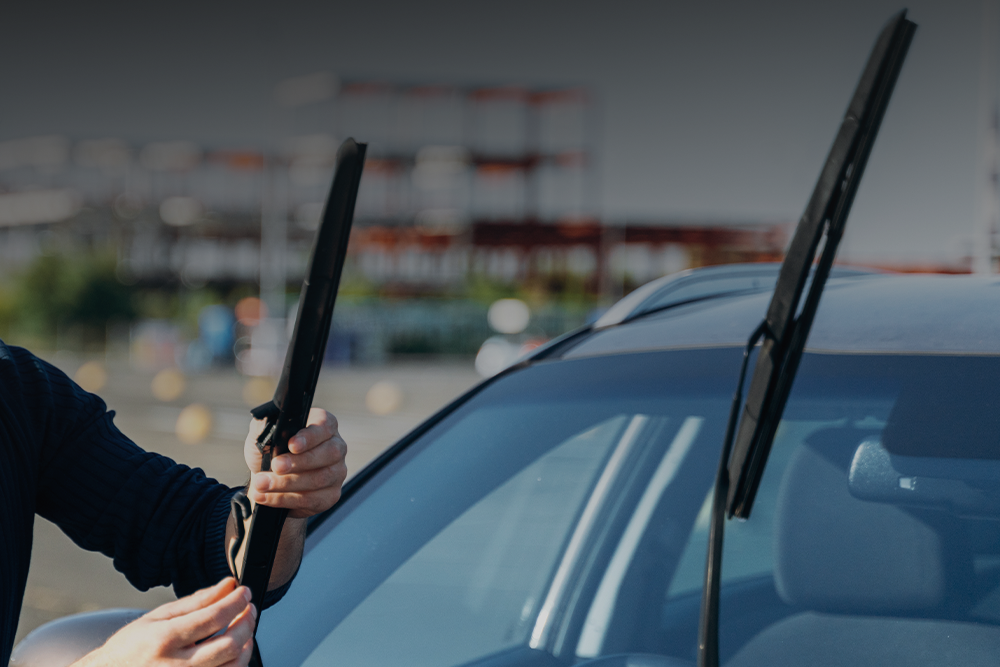 a person installing new windshield wiper blades